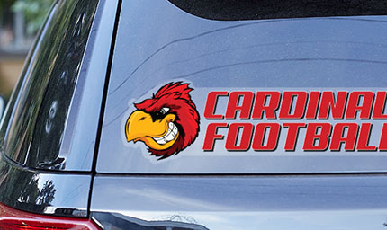 Clear window decal promoting the Cardinal Football Team on the rear window of an SUV.